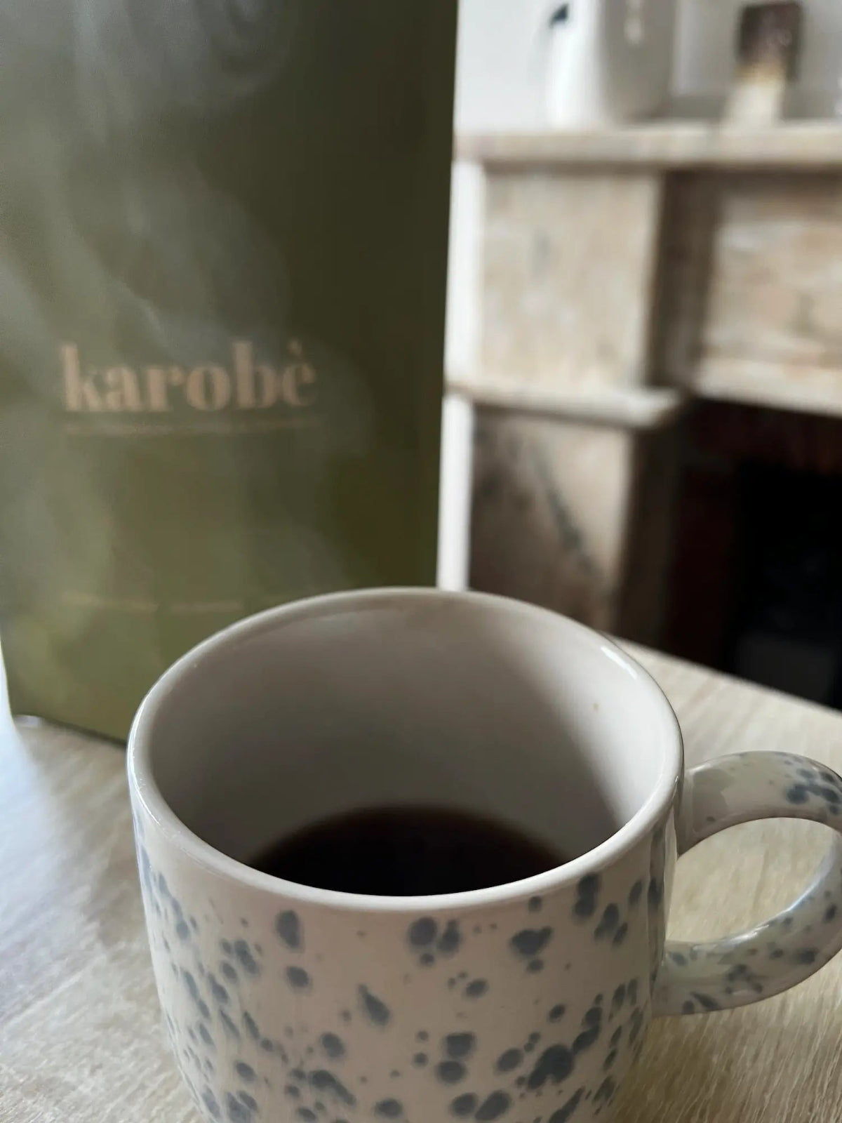Healthy caffeine-free coffee alternative: brewed Karobe roasted carob in a cup with powder texture detail.